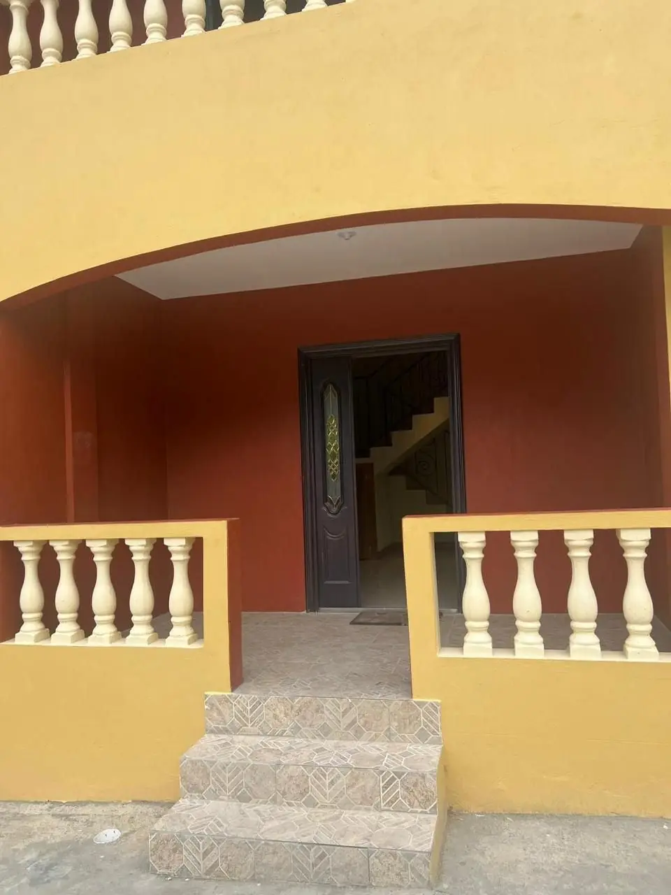 Arched front porch with balustrade
