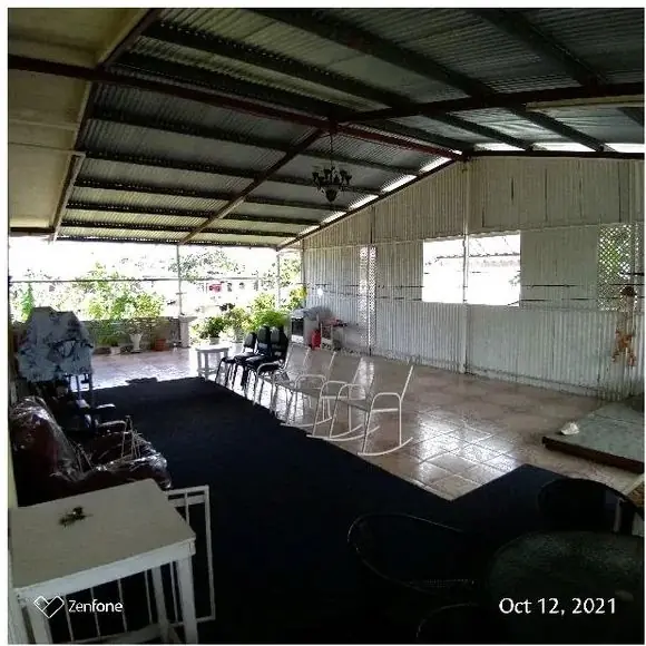 Covered open-plan space with tiled floor