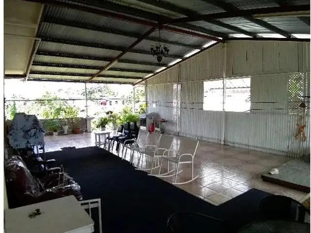 Covered open-plan space with tiled floor